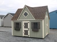 Pine Creek 8x10 Victorian Playhouse with PC Green walls, Navajo White trim and Bronze Z-Style shutters, and Barkwood shingles