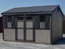 10x14 Peak Storage Shed with New England Package (wide trim, transom windows, etc), driftwood grey LP siding, black trim, and black metal roofing